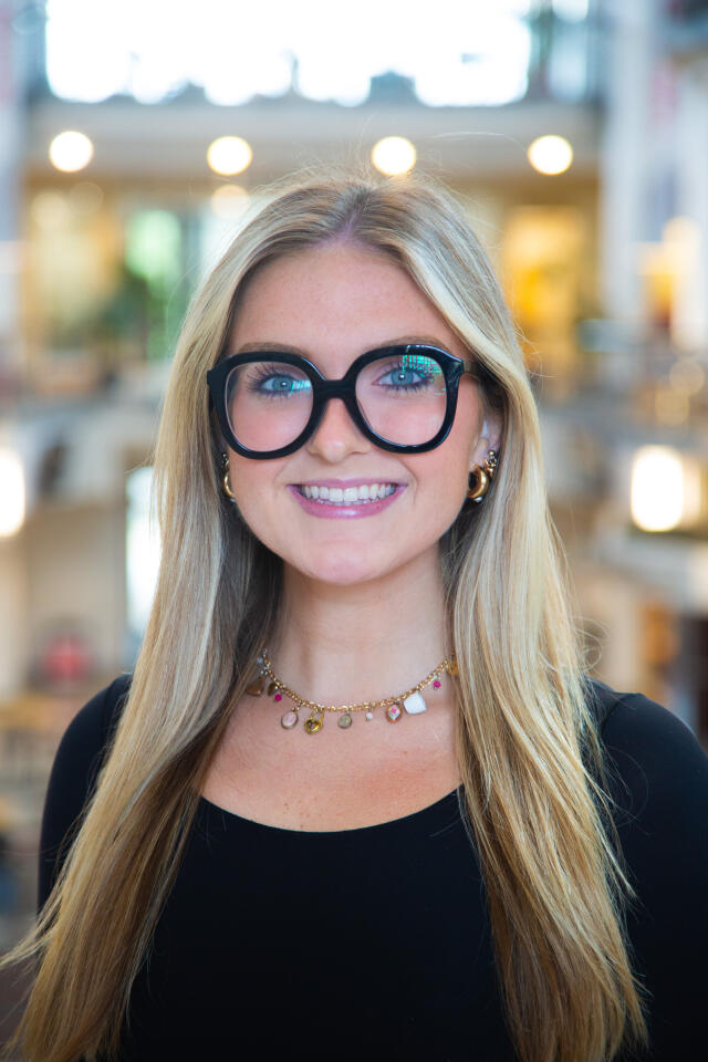 Profile photo of Delanie Householder standing in the Great Hall of the Ohio Union